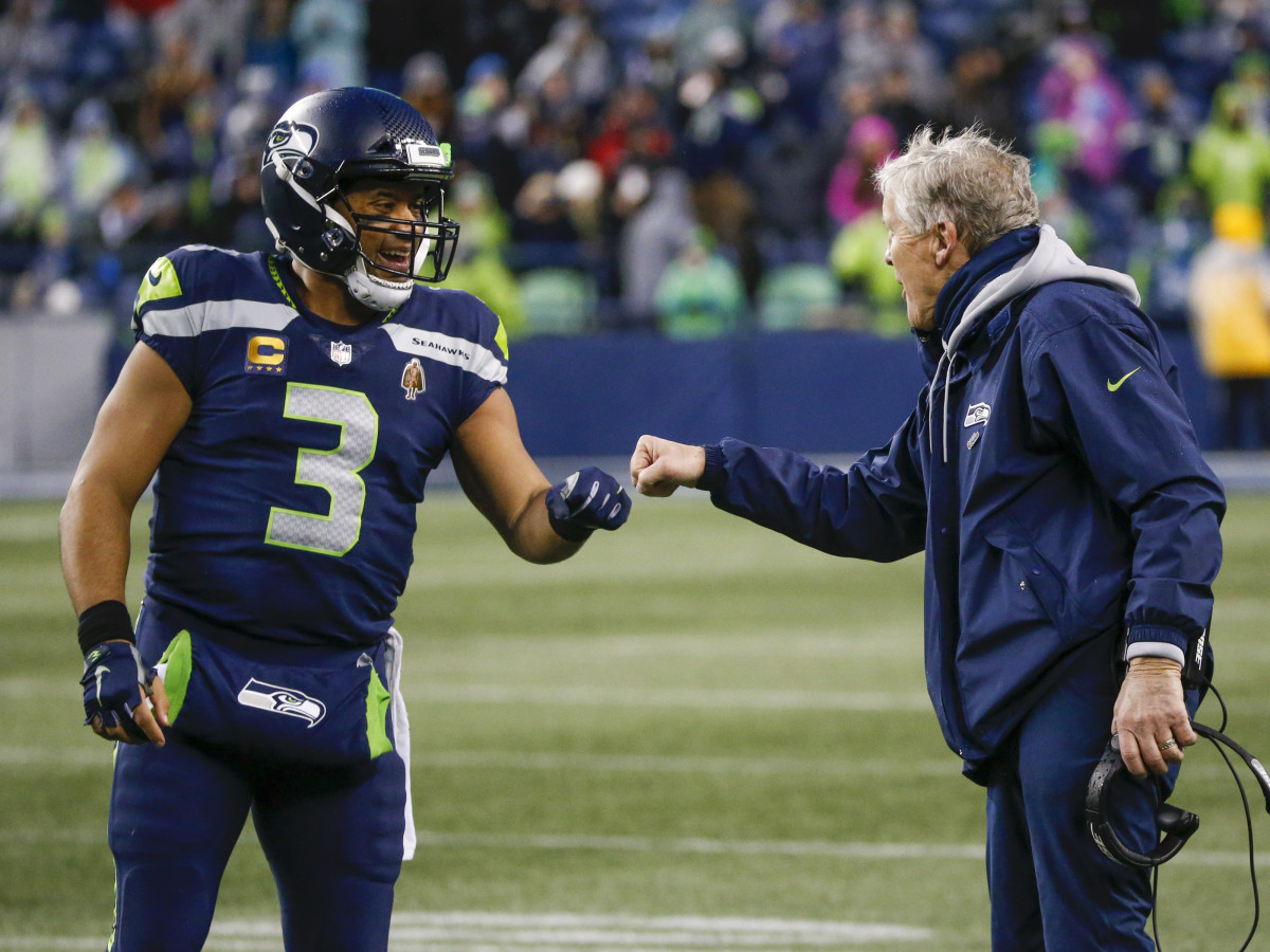 Seattle Seahawks quarterback Russell Wilson (3) bumps fists with head coach Pete Carroll during the fourth quarter two-minute warning against the Detroit Lions at Lumen Field.
