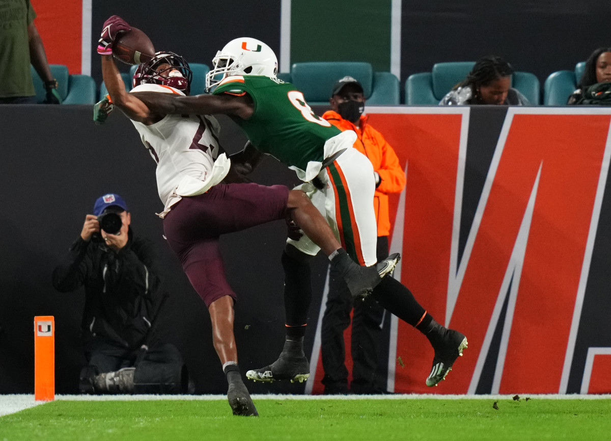 Nov 20, 2021; Miami Gardens, Florida, USA; Virginia Tech Hokies wide receiver Tre Turner (25) makes a one handed catch for a touchdown while defended by Miami Hurricanes cornerback DJ Ivey (8) during the first half at Hard Rock Stadium. Mandatory Credit: Jasen Vinlove-USA TODAY Sports
