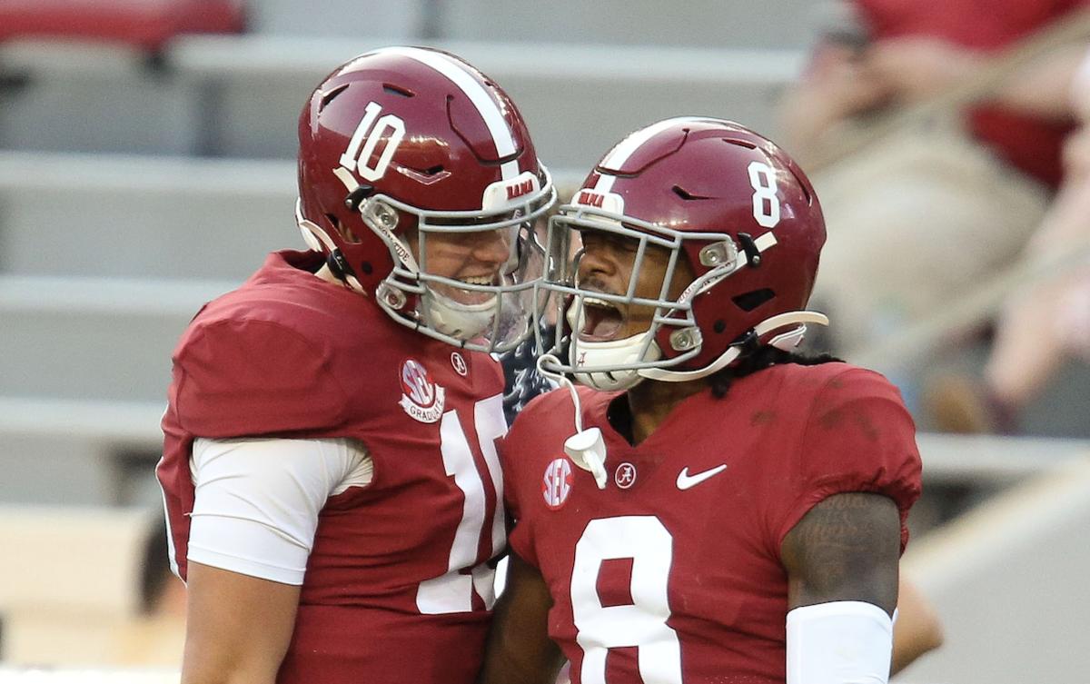 Alabama quarterback Mac Jones (10) celebrates with Alabama wide receiver John Metchie III (8) after they connected for a touchdown pass against Texas A&M at Bryant-Denny Stadium. Alabama defeated A&M 52-24.
