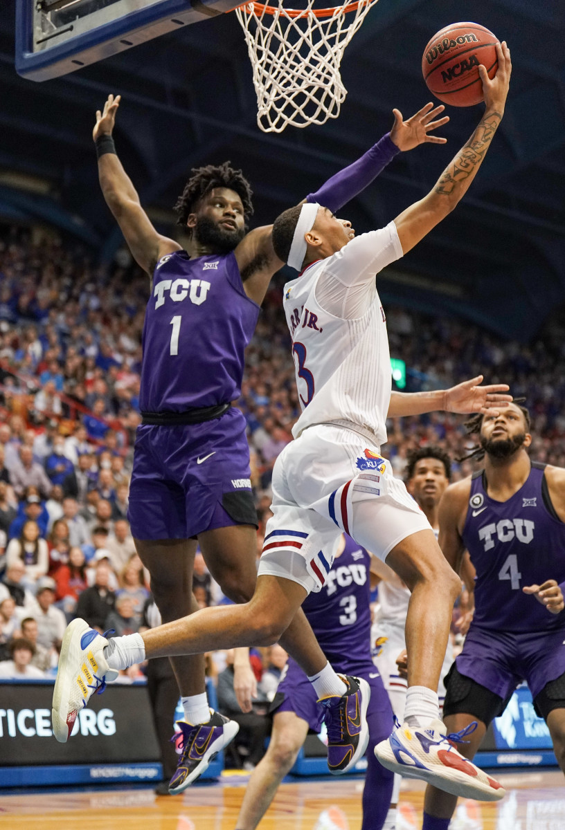 Mar 3, 2022; Lawrence, Kansas, USA; Kansas Jayhawks guard Dajuan Harris Jr. (3) shoots as TCU Horned Frogs guard Mike Miles (1) defends during the second half at Allen Fieldhouse. Mandatory Credit: Denny Medley-USA TODAY Sports