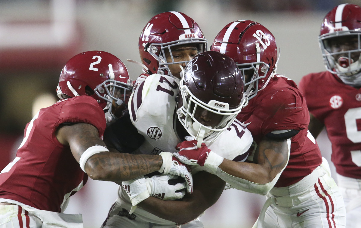 Alabama defensive back Patrick Surtain II (2), Alabama defensive back Brian Branch (14) and Alabama defensive back Malachi Moore (13) combine to tackle Mississippi State running back Jo'quavious Marks (21) at Bryant-Denny Stadium during the second half of Alabama's 41-0 win over Mississippi State.