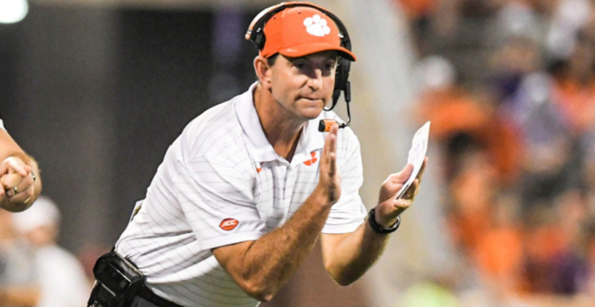 Clemson head coach Dabo Swinney celebrating a play from the sideline during a college football game in the ACC.