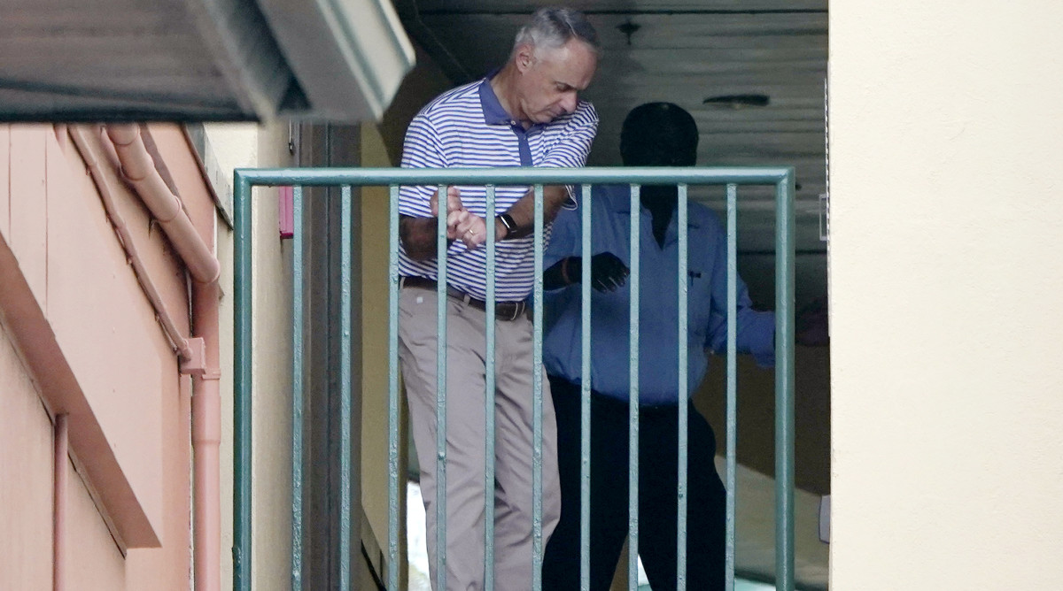 Major League Baseball Commissioner Rob Manfred practices his golf swing as negotiations continue with the players' association toward a labor deal, Tuesday, March 1, 2022, at Roger Dean Stadium in Jupiter, Fla.