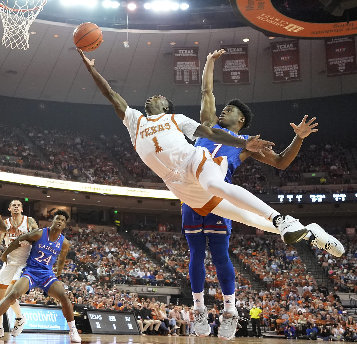 Texas Longhorns guard Andrew Jones (1) drives to the basket while defended by Kansas Jayhawks guard Joseph Yesufu (1) during the first half at Frank C. Erwin Jr. Center.