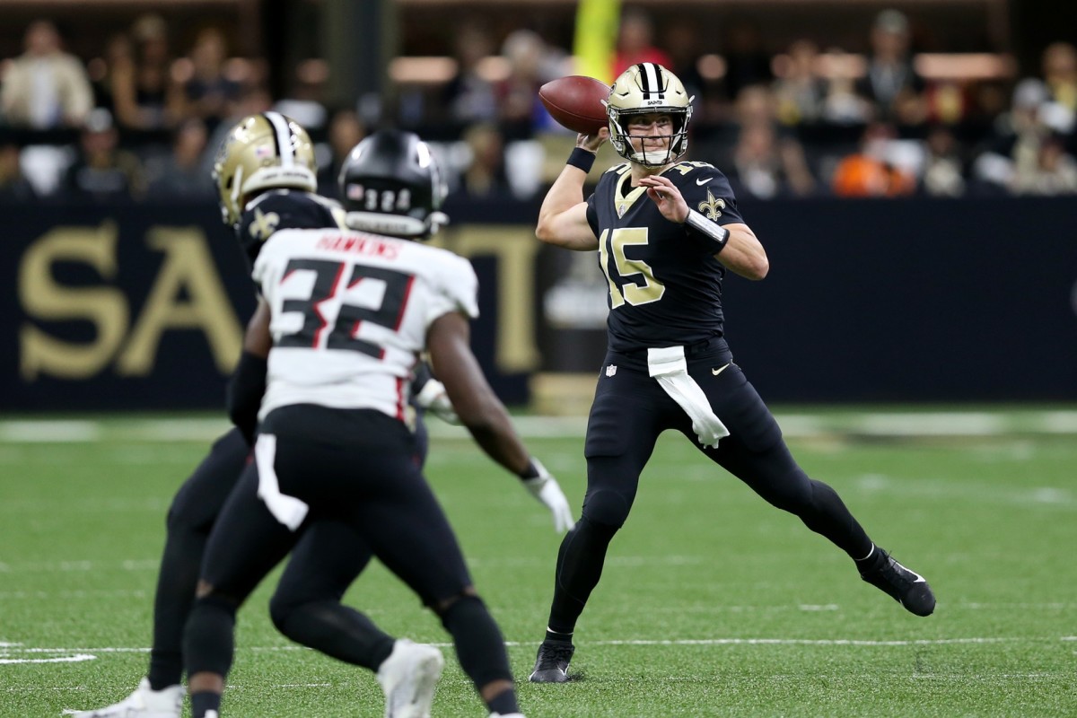 New Orleans Saints quarterback Trevor Siemian (15) throws on the run against the Falcons. Mandatory Credit: Chuck Cook-USA TODAY Sports