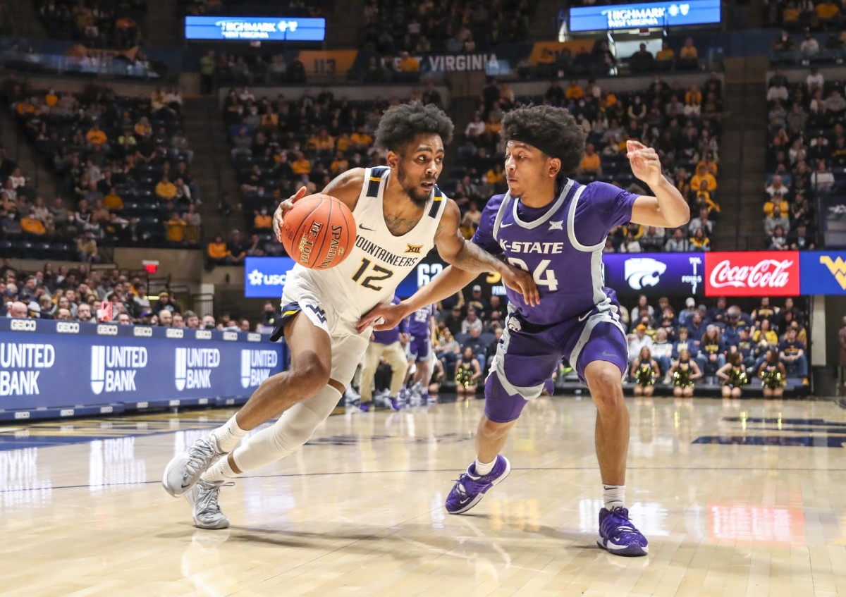 Jan 8, 2022; Morgantown, West Virginia, USA; West Virginia Mountaineers guard Taz Sherman (12) dribbles the ball against Kansas State Wildcats guard Nijel Pack (24) during the second half at WVU Coliseum.