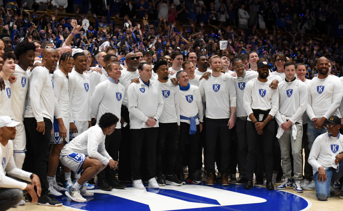 Mar 5, 2022; Durham, North Carolina, USA; Duke Blue Devils head coach Mike Krzyzewski poses for a picture with his former and current players prior to a game at Cameron Indoor Stadium.