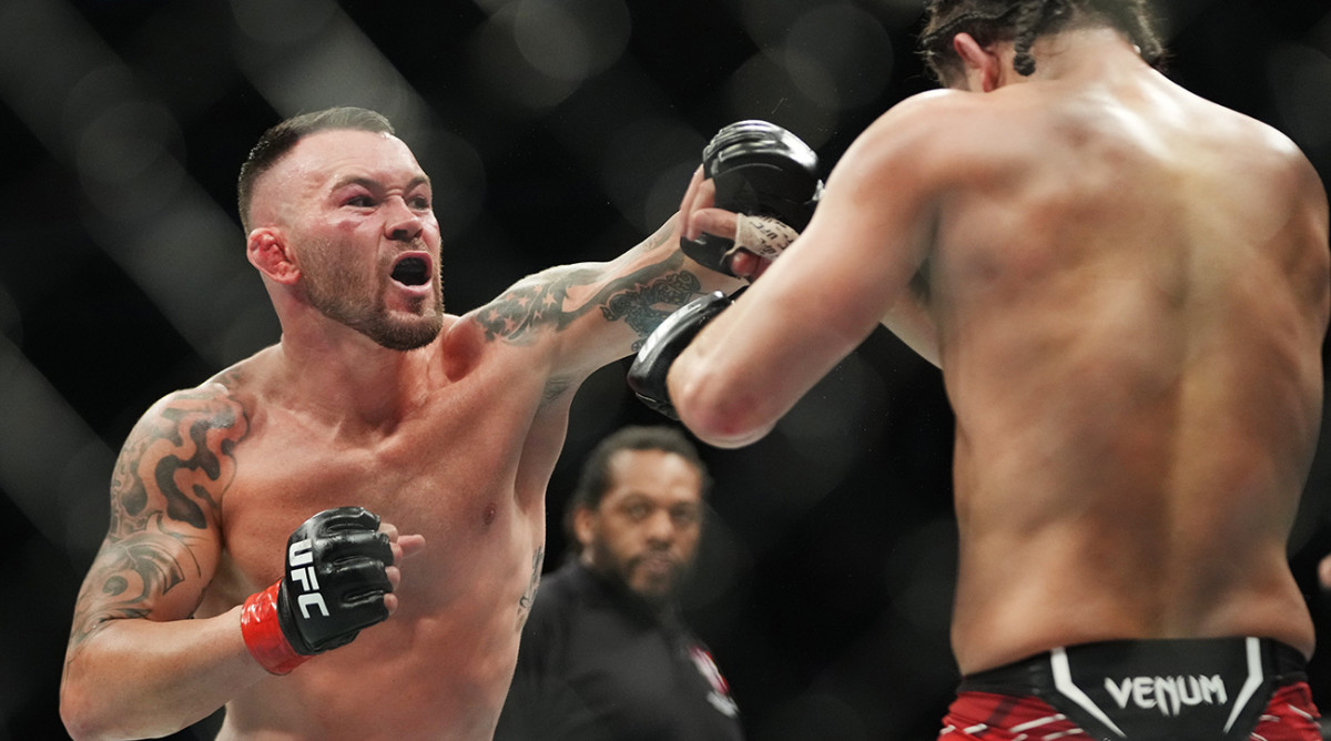 Colby Covington (red gloves) fights Jorge Masvidal (blue gloves) during UFC 272 at T-Mobile Arena.
