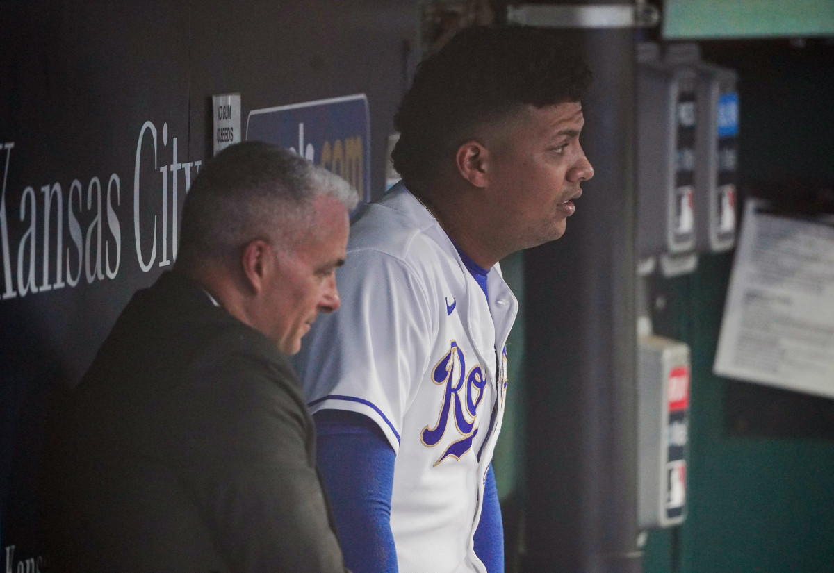 Sep 3, 2021; Kansas City, Missouri, USA; Kansas City Royals general manager Dayton Moore (left) sits with starting pitcher Carlos Hernandez (42) in the dugout while waiting out a rain delay before a game against the Chicago White Sox at Kauffman Stadium. Mandatory Credit: Denny Medley-USA TODAY Sports