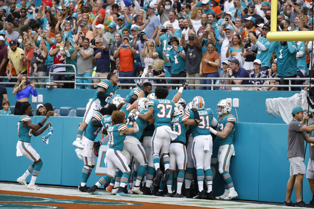 Jan 9, 2022; Miami Gardens, Florida, USA; The Miami Dolphins celebrate after cornerback Xavien Howard (25) scored a touchdown after intercepting the ball against the New England Patriots during the first quarter at Hard Rock Stadium. Mandatory Credit: Rhona Wise-USA TODAY Sports