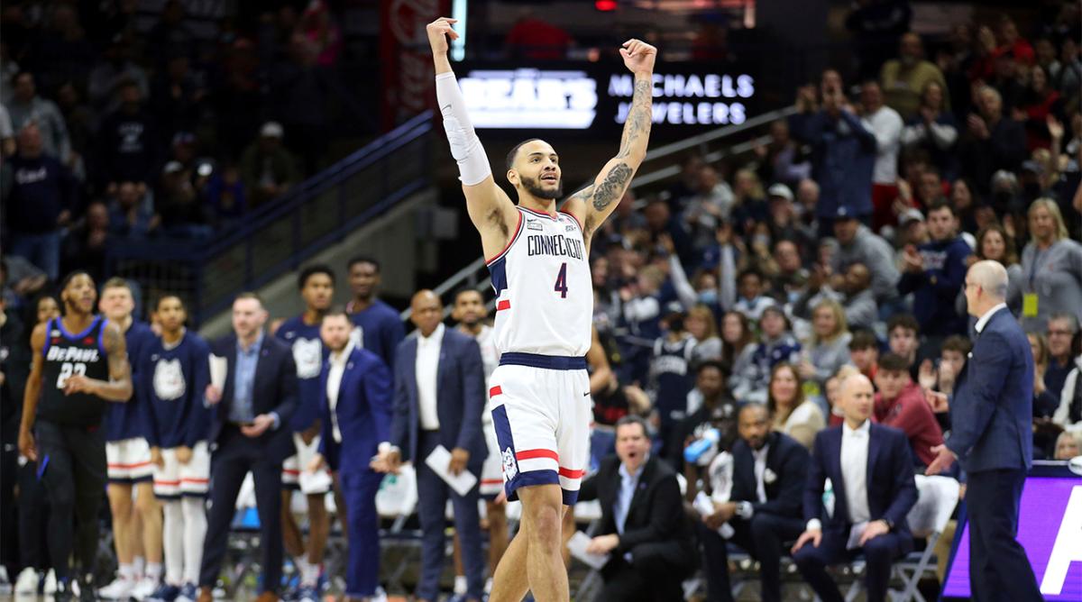 Connecticut's Tyrese Martin (4) celebrates during the first half of an NCAA college basketball game against DePaul Saturday, March 5, 2022, in Storrs, Conn.