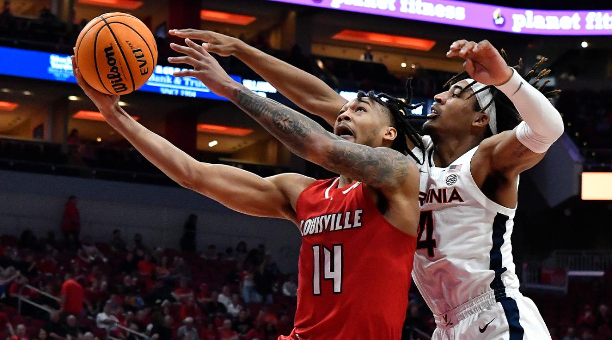 Virginia guard Armaan Franklin (4) attempts to block a shot by Louisville guard Dre Davis (14) during the second half of an NCAA college basketball game in Louisville, Ky., Saturday, March 5, 2022. Virginia won 71-61.