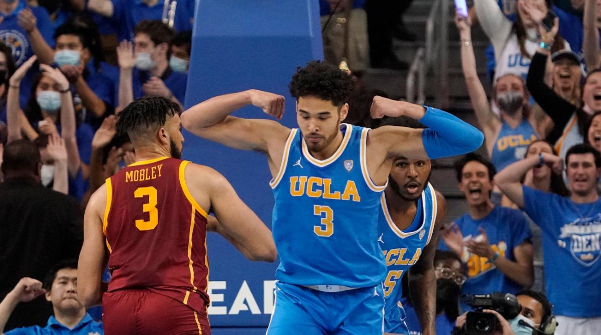 UCLA guard Johnny Juzang, right, celebrates after scoring as Southern California forward Isaiah Mobley, left, stands by during the first half of an NCAA college basketball game Saturday, March 5, 2022, in Los Angeles.