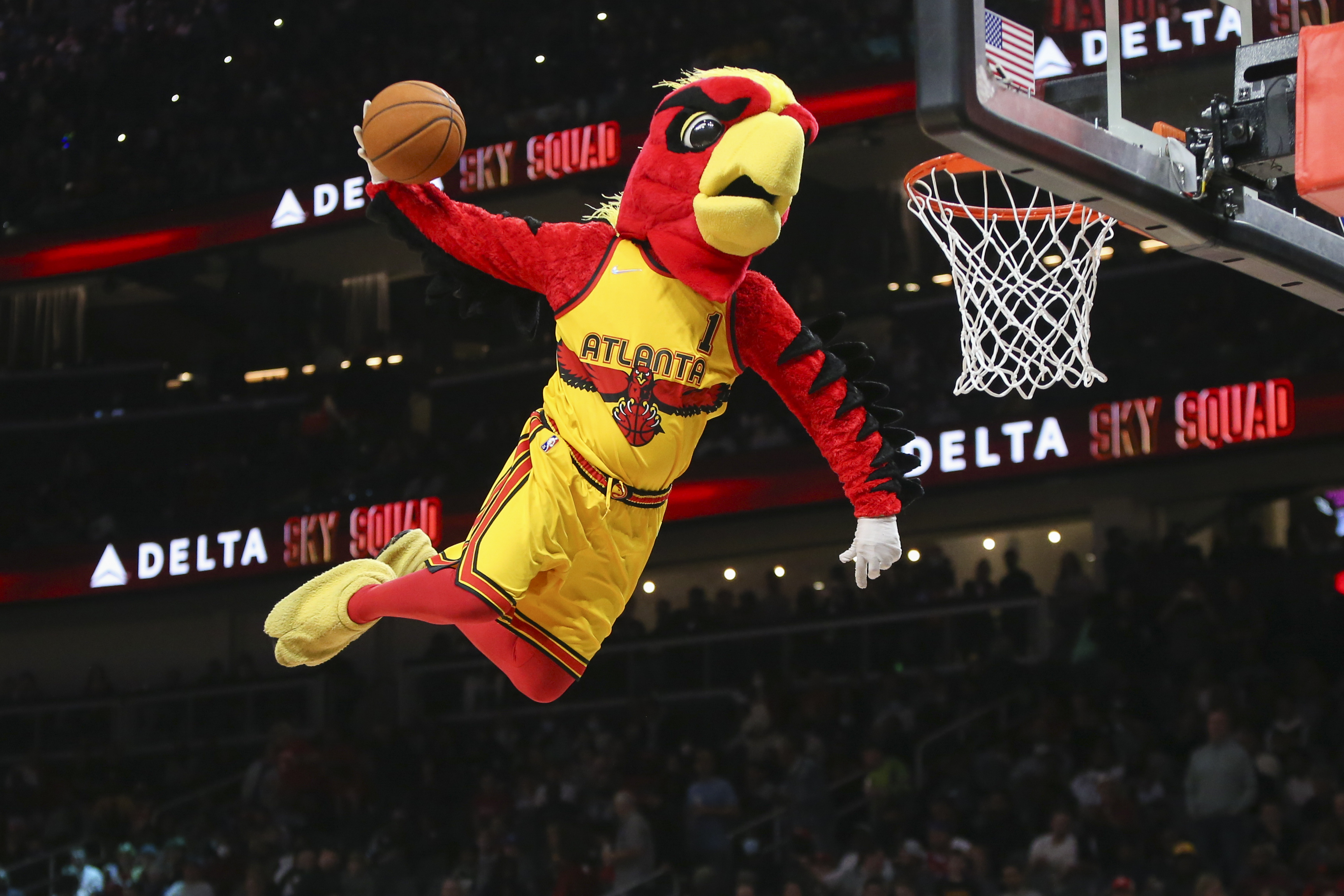 Dec 3, 2021; Atlanta, Georgia, USA; Atlanta Hawks mascot Harry the Hawk dunks during a timeout against the Philadelphia 76ers in the second quarter at State Farm Arena.