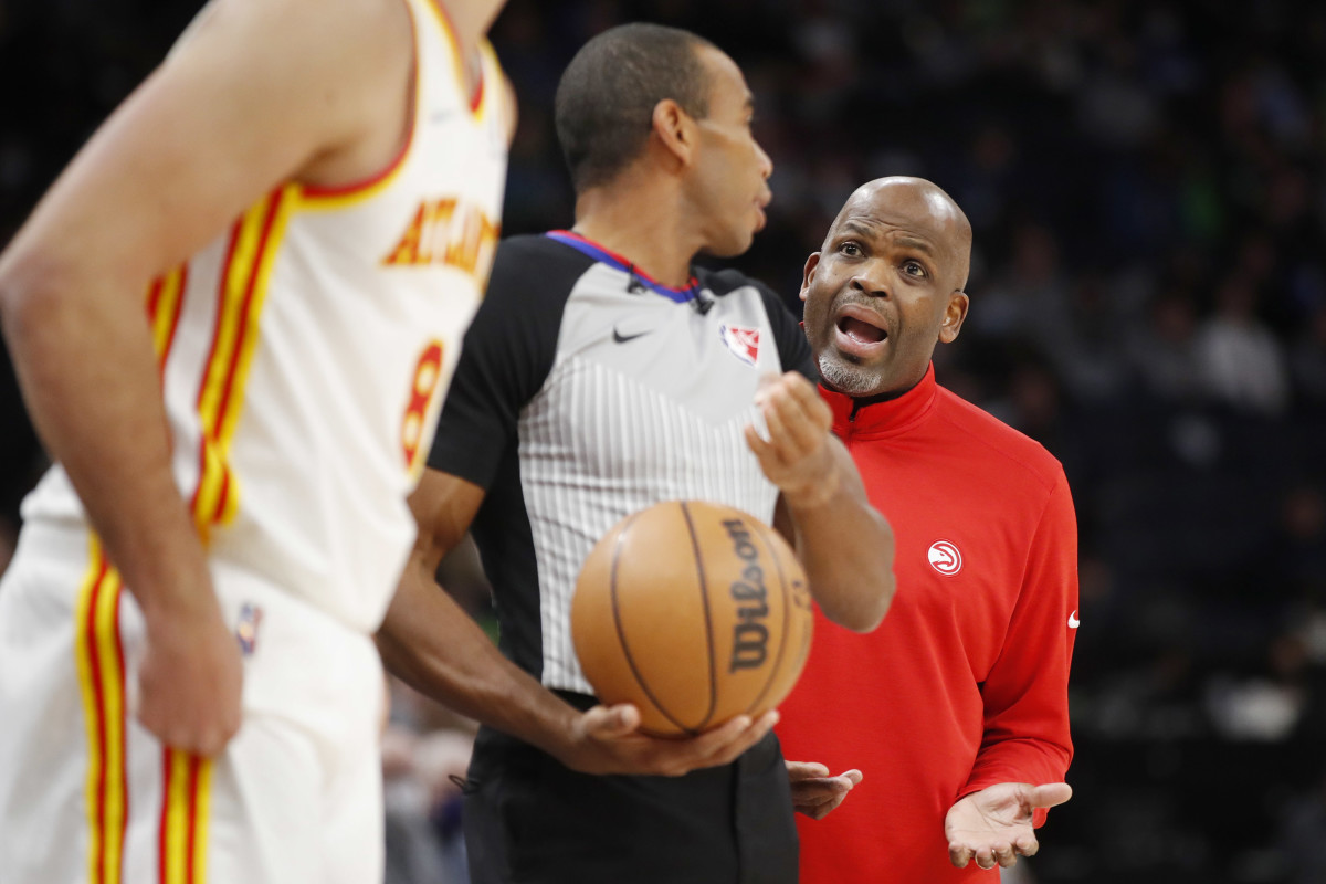 Dec 6, 2021; Minneapolis, Minnesota, USA; Atlanta Hawks head coach Nate McMillan questions referee Phenizee Ransom (70) about a call in the game with the Minnesota Timberwolves at Target Center.