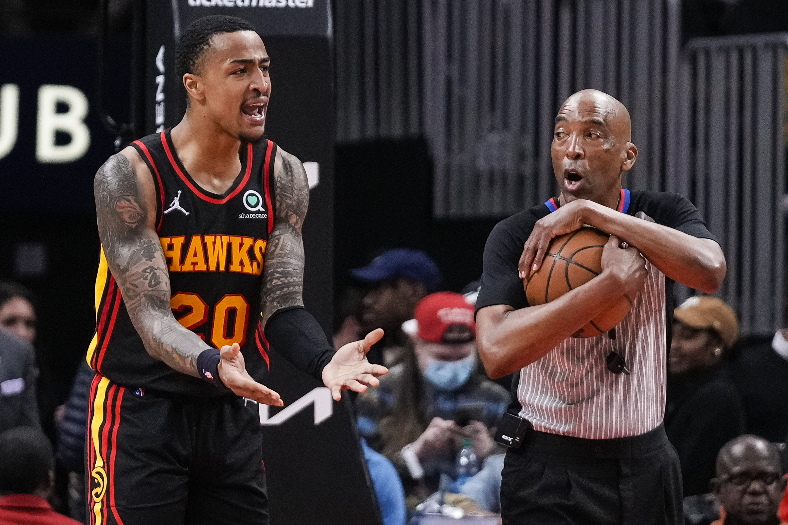 Jan 21, 2022; Atlanta, Georgia, USA; Atlanta Hawks forward John Collins (20) reacts to referee Leon Wood (40) after being called for a foul during the second half against the Miami Heat at State Farm Arena.