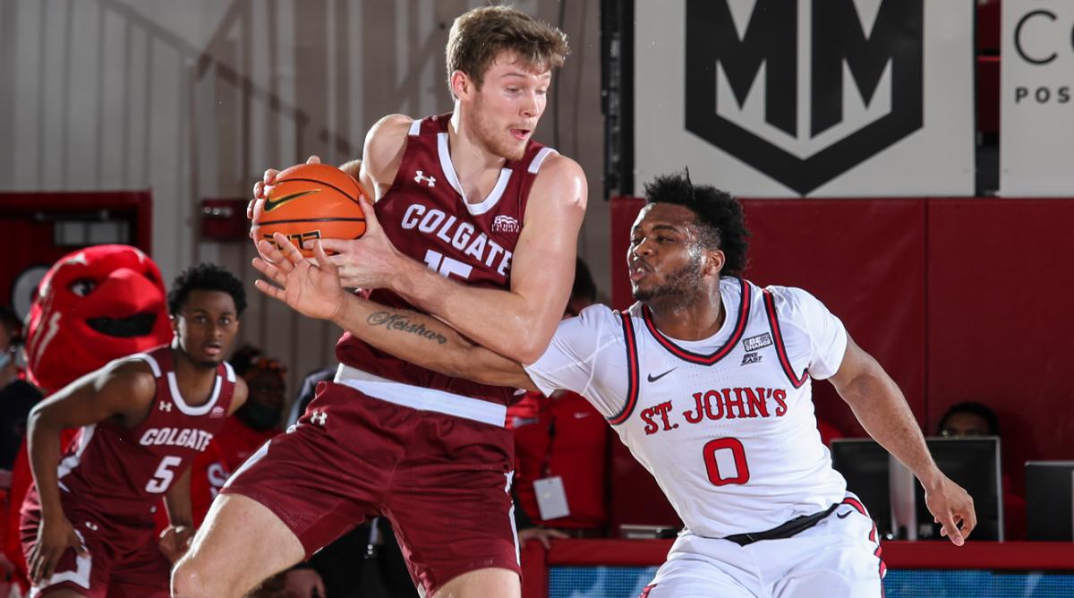Dec 12, 2021; Queens, New York, USA; St. John s Red Storm guard Posh Alexander (0) tries to knock the ball away from Colgate Raiders guard Tucker Richardson (15) in the second half at Carnesecca Arena. Mandatory Credit: