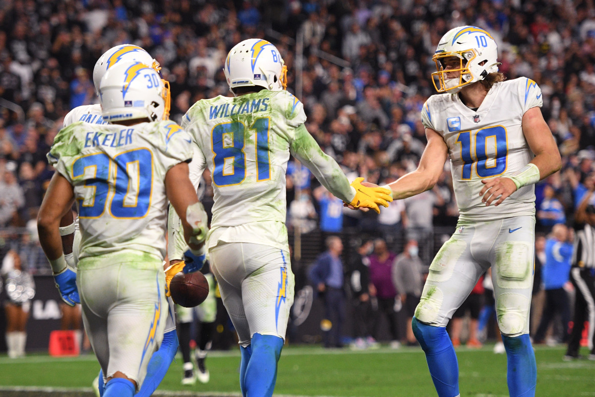 Jan 9, 2022; Paradise, Nevada, USA; Los Angeles Chargers quarterback Justin Herbert (10) and wide receiver Mike Williams (81) celebrate after a touchdown catch during the second half against the Las Vegas Raiders at Allegiant Stadium. Mandatory Credit: Orlando Ramirez-USA TODAY Sports