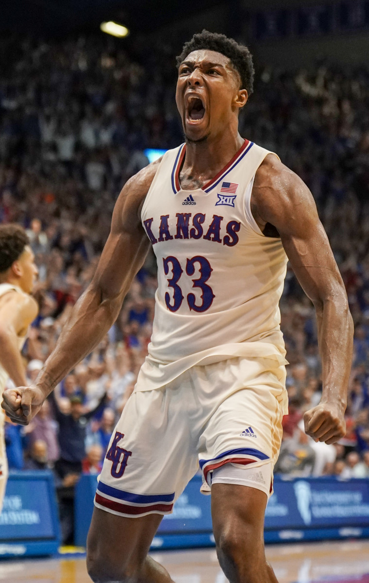 Mar 5, 2022; Lawrence, Kansas, USA; Kansas Jayhawks forward David McCormack (33) celebrates after dunking the ball against the Texas Longhorns in overtime at Allen Fieldhouse. Mandatory Credit: Denny Medley-USA TODAY Sports