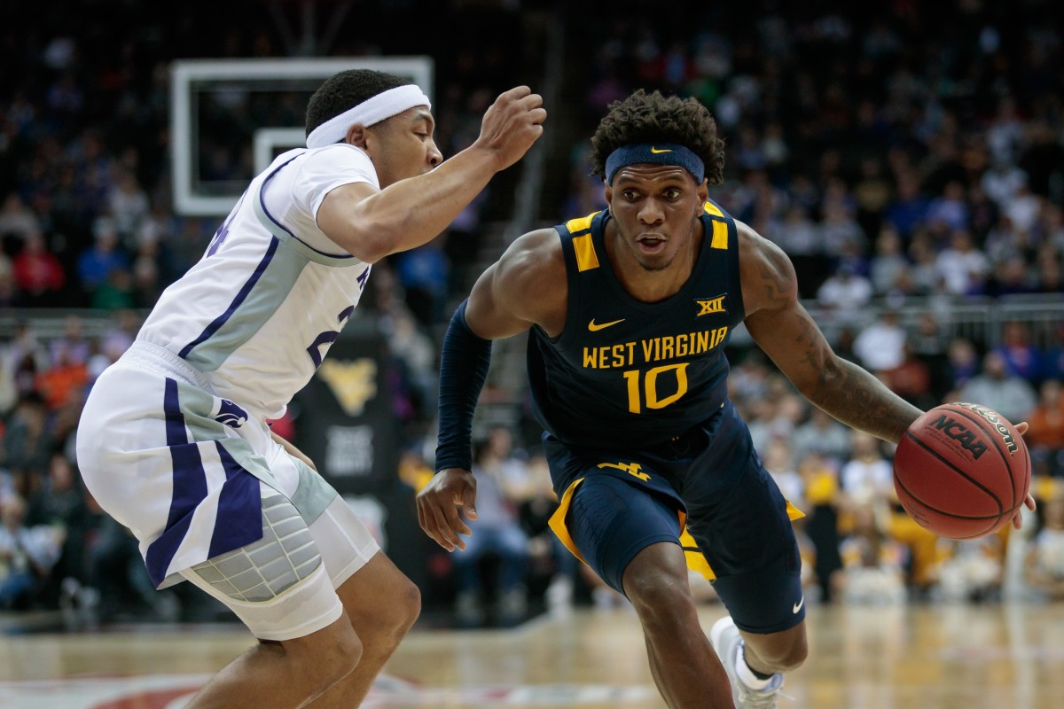 Mar 9, 2022; Kansas City, MO, USA; West Virginia Mountaineers guard Malik Curry (10) drives around Kansas State Wildcats guard Nijel Pack (24) during the first half at T-Mobile Center.