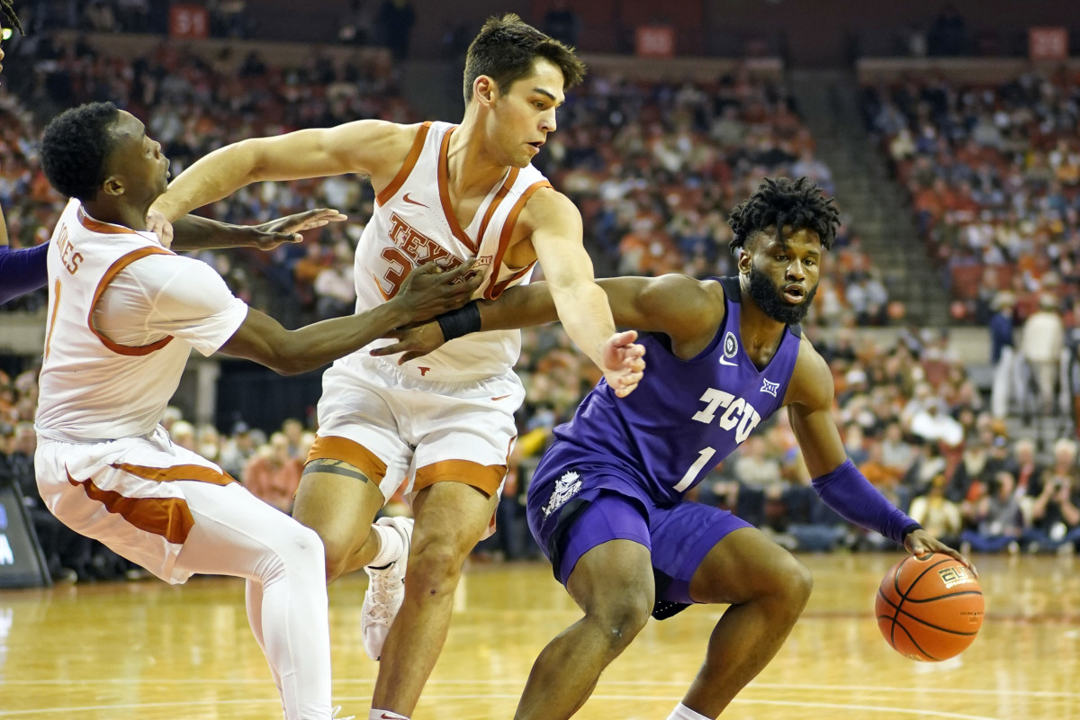 Feb 23, 2022; Austin, Texas, USA; Texas Christian Horned Frogs guard Mike Miles Jr. (1) looks to pass the ball while defended by Texas Longhorns forward Brock Cunningham (30) and guard Andrew Jones (1) during the second half at Frank C. Erwin Jr. Center. Mandatory Credit: Scott Wachter-USA TODAY Sports