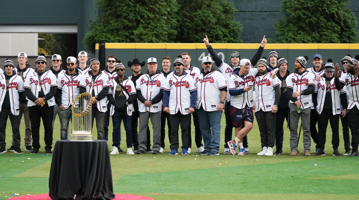 Nov 5, 2021; Atlanta, GA, USA; Atlanta Braves players and team pose with the Commissioner’s Trophy during the World Series championship rally at Truist Park.