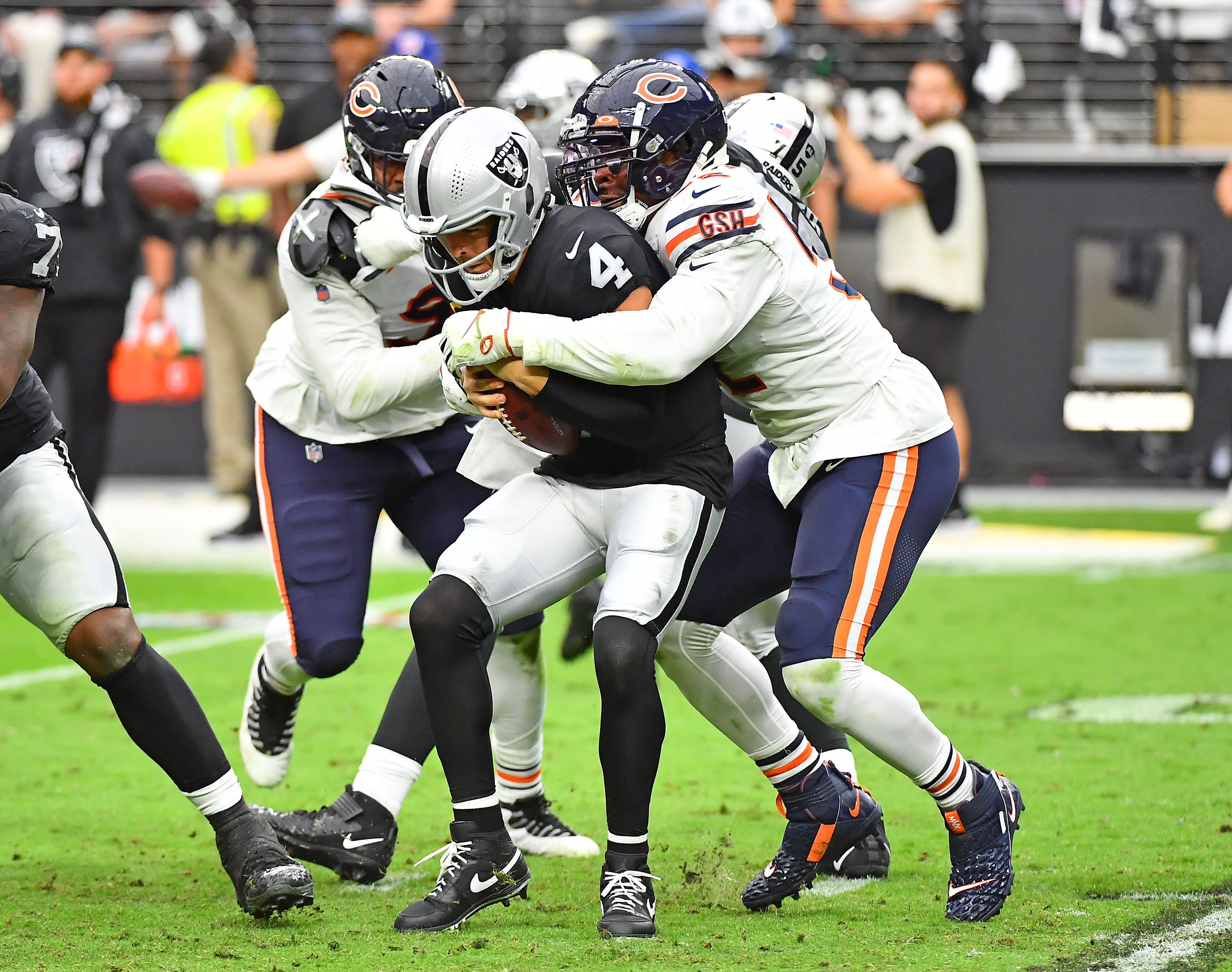 Oct 10, 2021; Paradise, Nevada, USA; Las Vegas Raiders quarterback Derek Carr (4) is sacked by Chicago Bears outside linebacker Khalil Mack (52) during the first half of a game at Allegiant Stadium. Mandatory Credit: Stephen R. Sylvanie-USA TODAY Sports