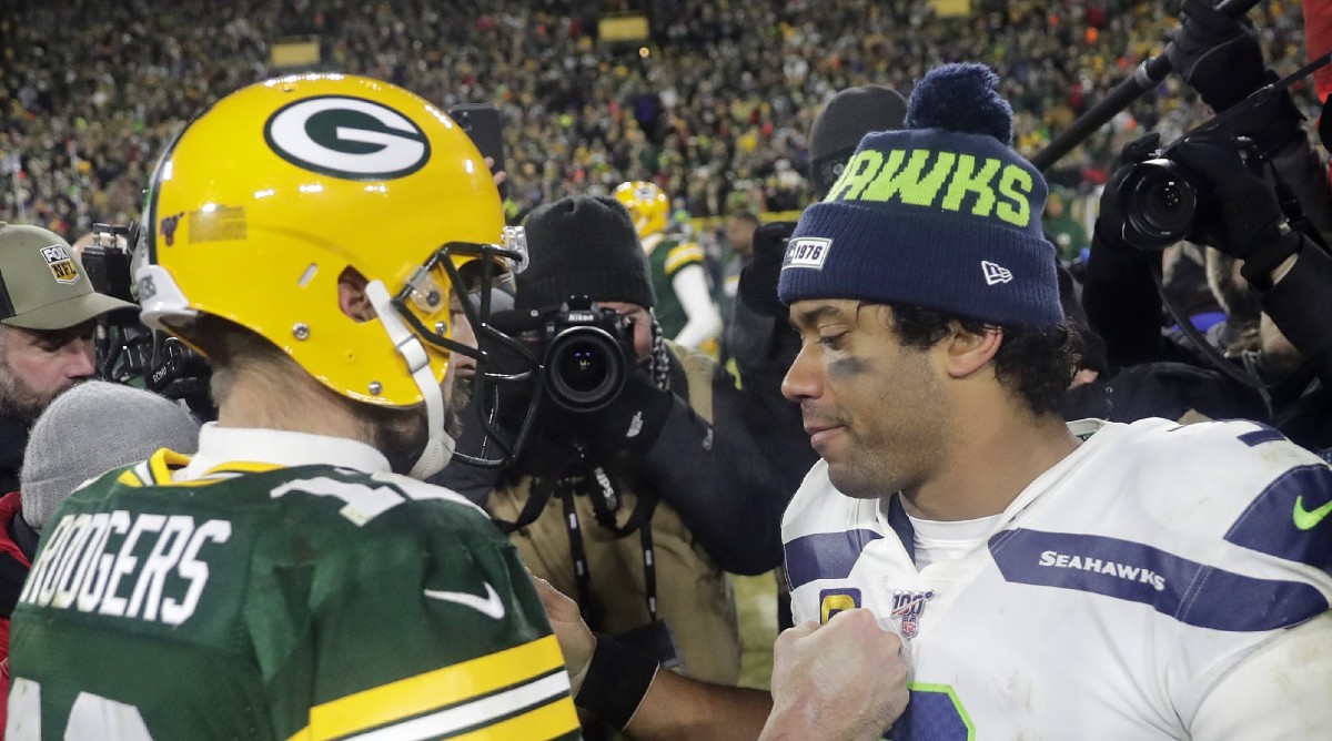 Aaron Rodgers and Russell Wilson meet at midfield.