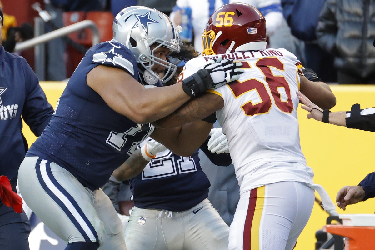 Dec 12, 2021; Landover, Maryland, USA; Dallas Cowboys offensive tackle La'el Collins (71) gets into an altercation with Washington Football Team defensive end Will Bradley-King (56) after his hit on Cowboys quarterback Dak Prescott (not pictured) during the fourth quarter at FedExField.