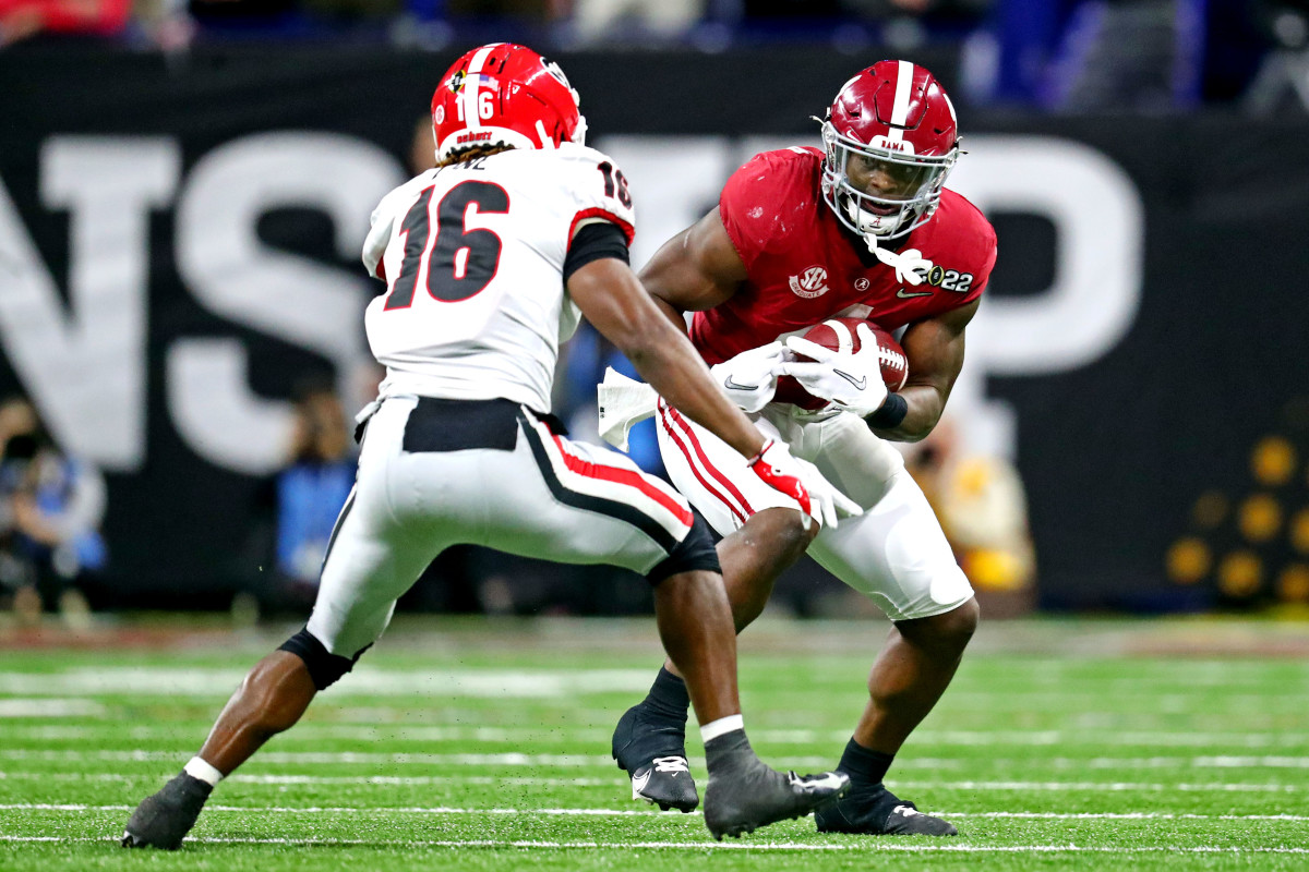 Jan 10, 2022; Indianapolis, IN, USA; Alabama Crimson Tide running back Brian Robinson Jr. (4) runs the ball against Georgia Bulldogs defensive back Lewis Cine (16) during the third quarter in the 2022 CFP college football national championship game at Lucas Oil Stadium. Mandatory Credit: Mark J. Rebilas-USA TODAY Sports