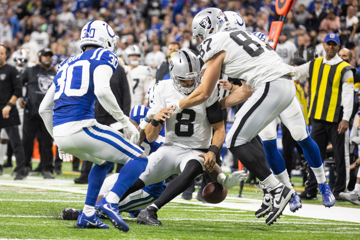 Jan 2, 2022; Indianapolis, Indiana, USA; Las Vegas Raiders quarterback Marcus Mariota (8) fumbles the ball in the first half against the Indianapolis Colts at Lucas Oil Stadium. Mandatory Credit: Trevor Ruszkowski-USA TODAY Sports