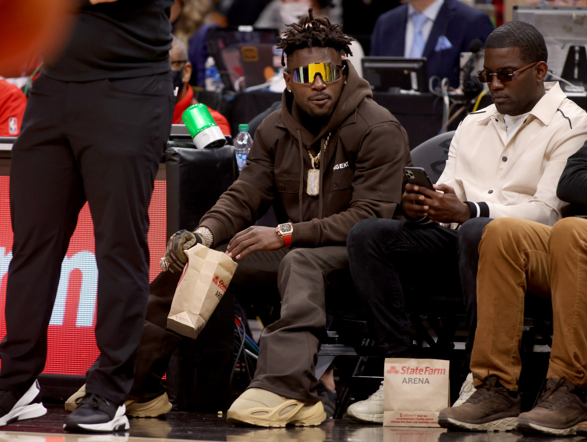 Mar 11, 2022; Atlanta, Georgia, USA; Former Tampa Bay Buccaneers wide receiver Antonio Brown watches the game between the Atlanta Hawks and the LA Clippers during the second quarter at State Farm Arena.