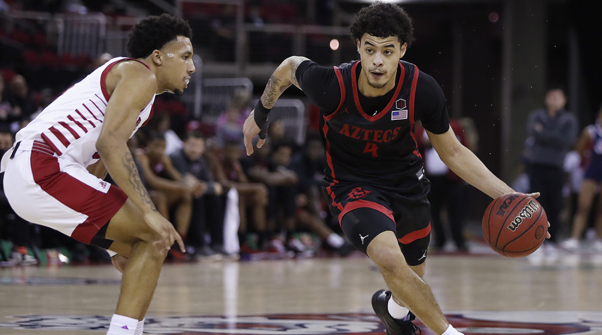 San Diego State's Trey Pulliam, right, drives past a Fresno State's defender during the first half of an NCAA college basketball game in Fresno, Calif., Saturday, Feb. 19, 2022.