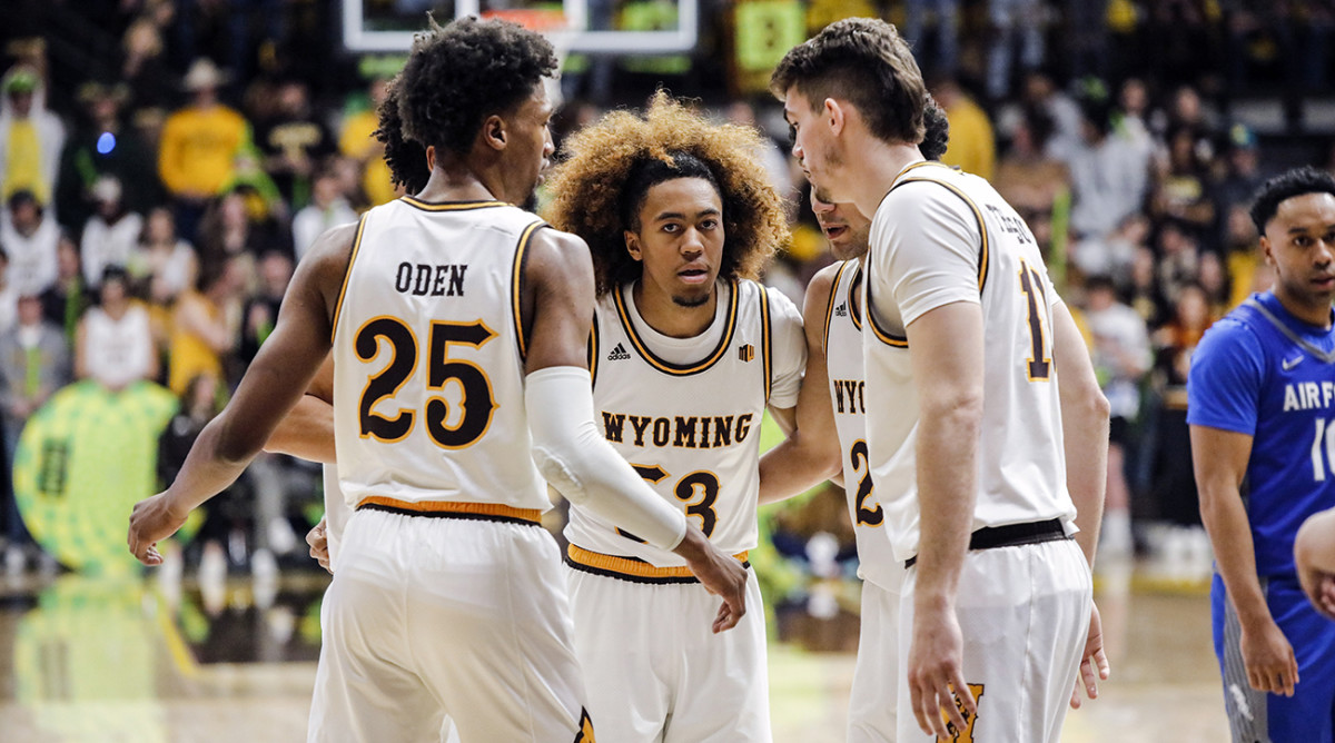 Wyoming guard Xavier DuSell (53), Wyoming forward Jeremiah Oden (25), and Wyoming forward Hunter Thompson (10) huddle after a foul during the second half of an NCAA college basketball game against Air Force, Saturday, Feb. 19, 2022, in Laramie, Wyo.