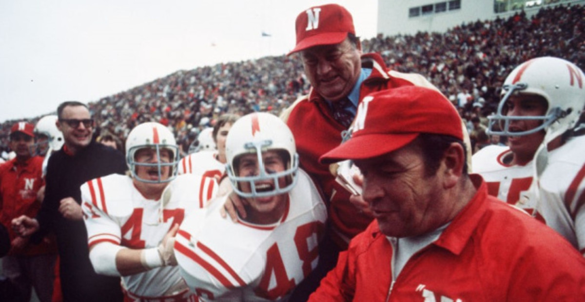 Nebraska Cornhuskers head coach Bob Devaney hoisted by his players after a college football game.