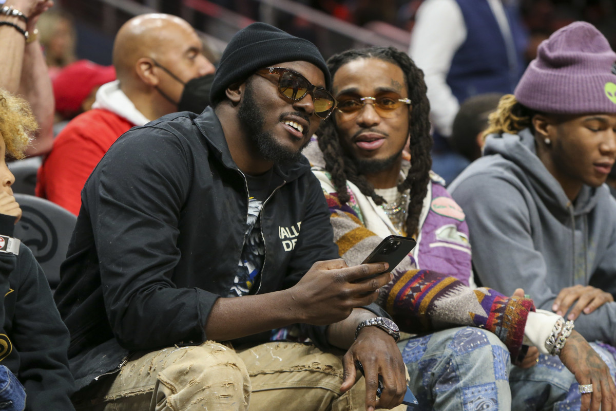 Mar 13, 2022; Atlanta, Georgia, USA; Cleveland Browns safety Richard LeCounte talks to rapper Quavo during a game between the Atlanta Hawks and Indiana Pacers in the second quarter at State Farm Arena.