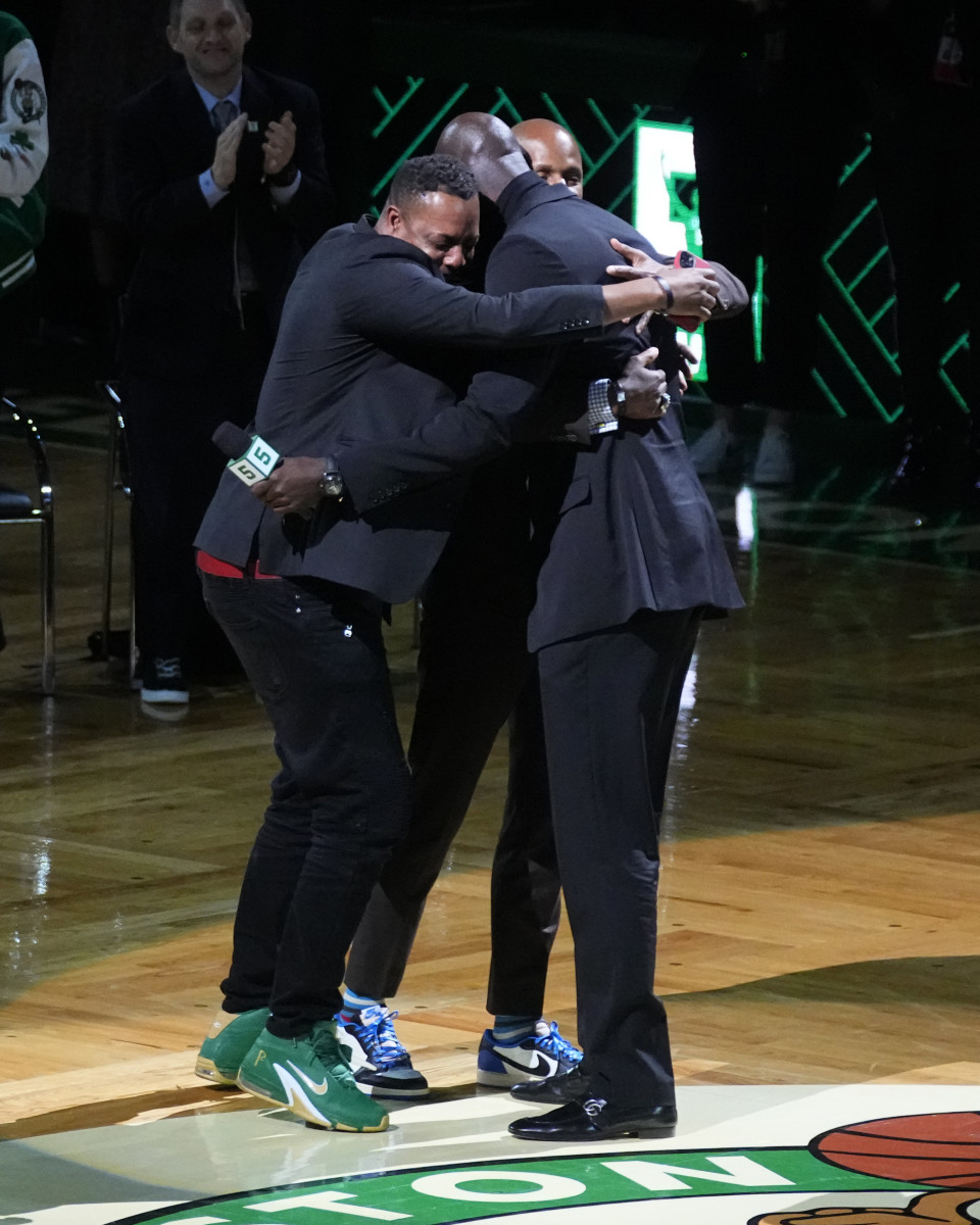 Basketball Hall of Famer and former Boston Celtic, Kevin Garnett embraces former Boston Celtics players, Ray Allan and Paul Pierce during the number retirement ceremony after the game between the Boston Celtics the Dallas Mavericks at TD Garden.