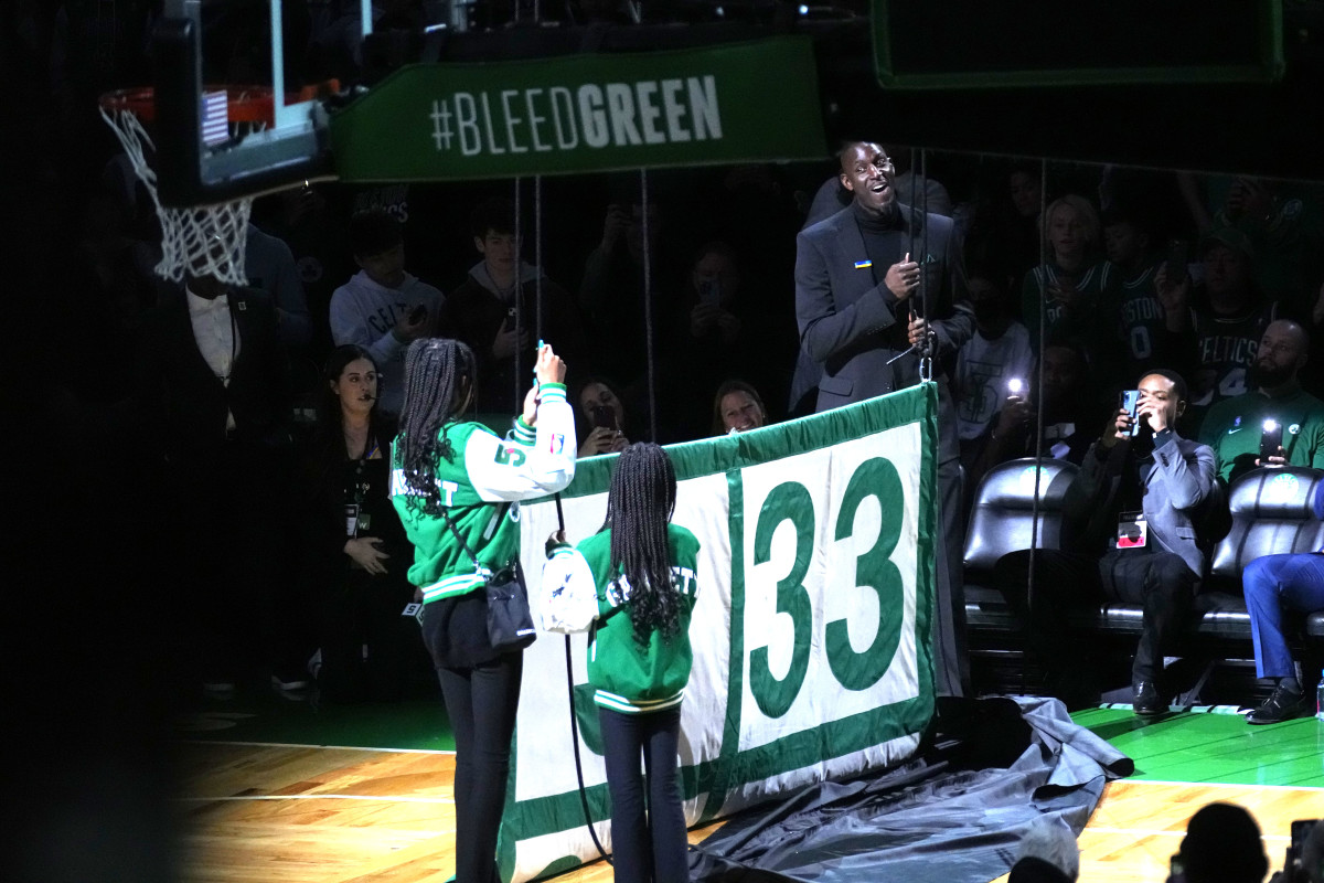 Former Boston Celtic and Basketball Hall of Famer, Kevin Garnett along with his daughters help raise his number 5 to the rafters along with the other retired players numbers after the game between the Boston Celtics and Dallas Mavericks at TD Garden.
