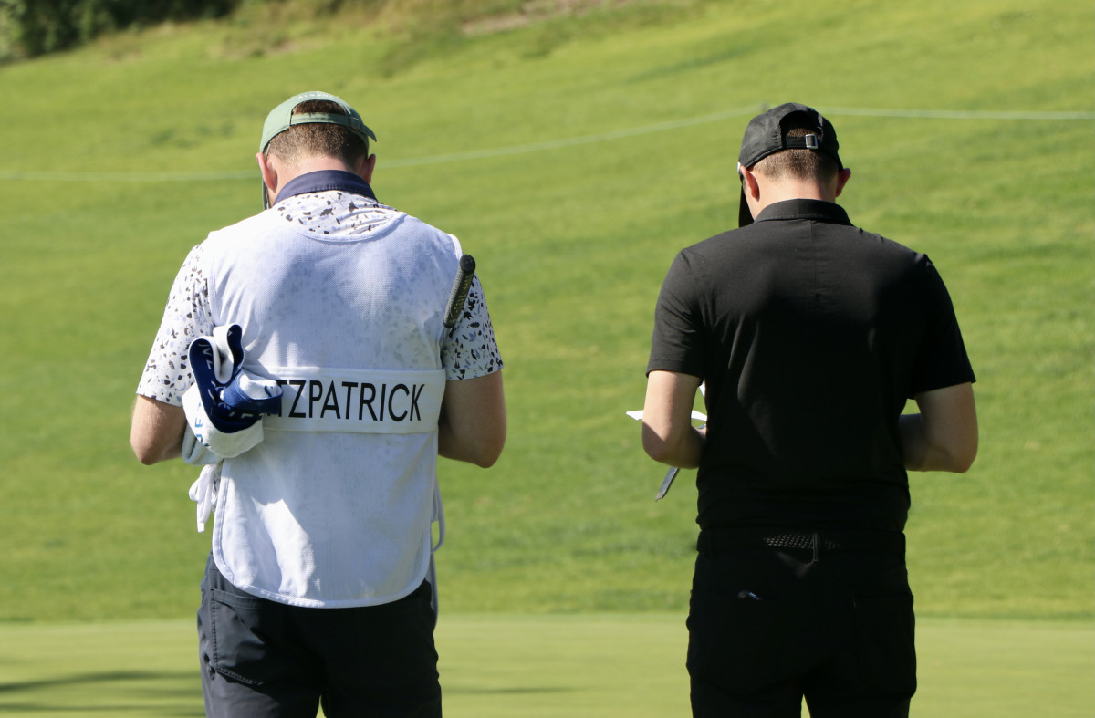 Matt Fitzpatrick (right) and his caddy stand on the 18th hole of the Riviera Country Club, finishing up the golfer's participation in the Genesis Invitational Collegiate Showcase.