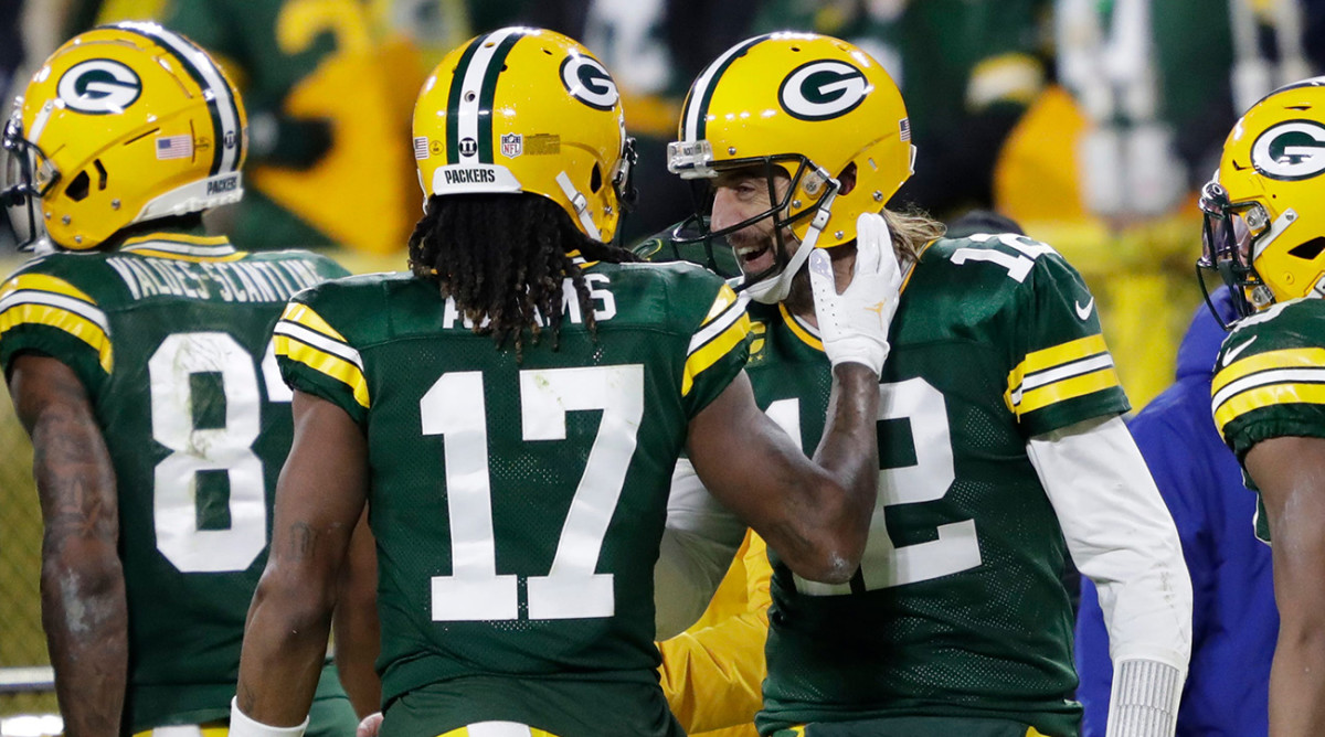 Green Bay Packers wide receiver Davante Adams (17) celebrates his touchdown reception with quarterback Aaron Rodgers (12) in the second quarter against the Chicago Bears during their football game Sunday, December 12, 2021, at Lambeau Field in Green Bay, Wis.
