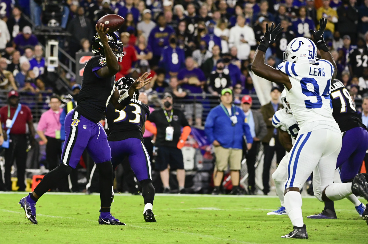 Oct 11, 2021; Baltimore, Maryland, USA; Baltimore Ravens quarterback Lamar Jackson (8) throws as Indianapolis Colts defensive end Tyquan Lewis (94) defends during the first half at M&T Bank Stadium.