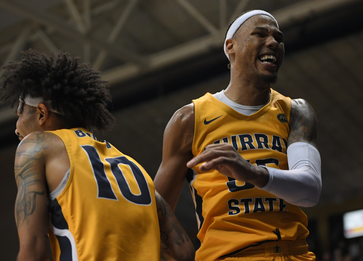 Feb 24, 2022; Murray, Kentucky, USA; Murray State Racers guard Tevin Brown (10) and forward DJ Burns (55) celebrate a 3 pt shot from guard Rod Thomas (25) against the Belmont Bruins during second half at CFSB Center. Mandatory Credit: Steve Roberts-USA TODAY Sports