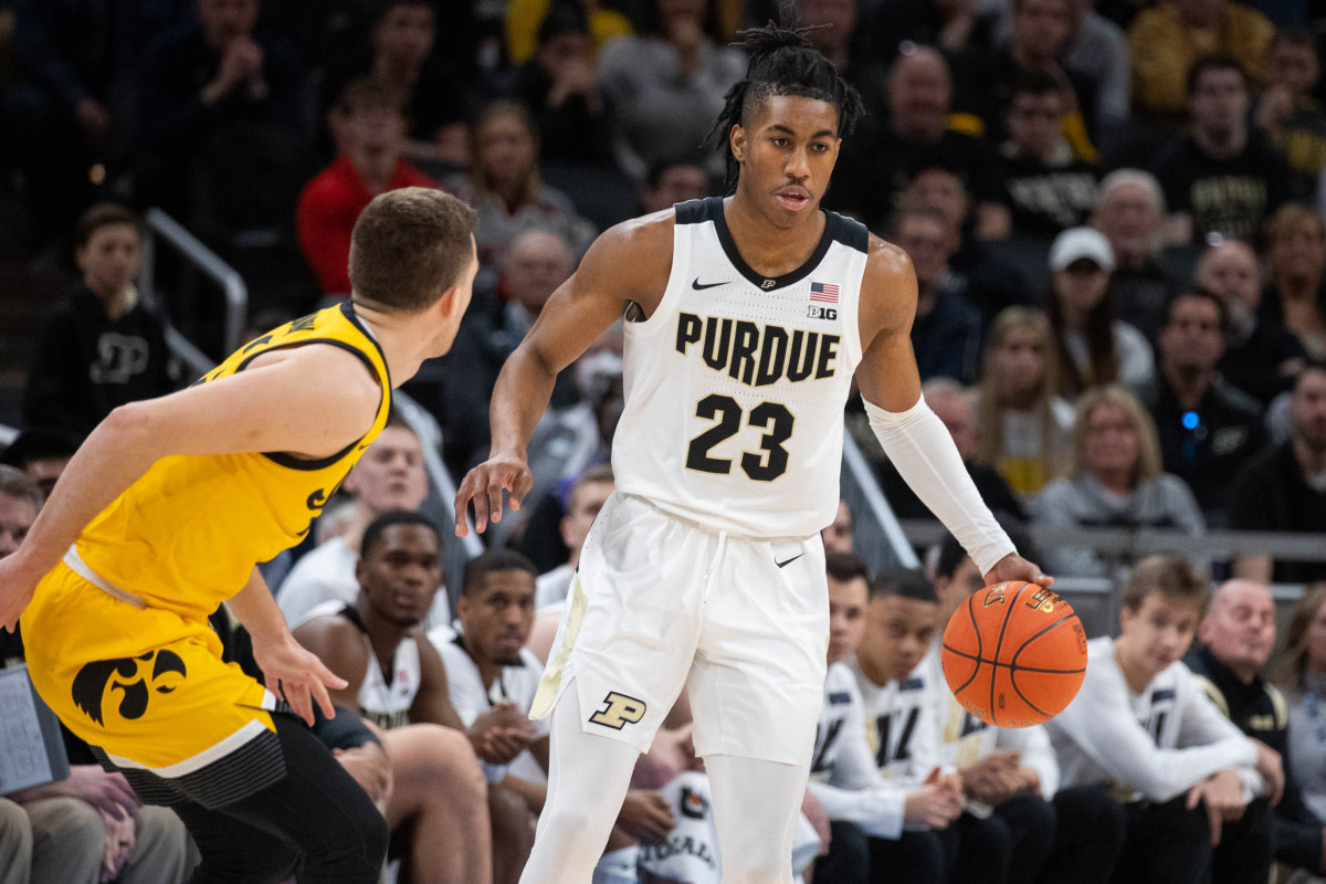 Mar 13, 2022; Indianapolis, IN, USA; Purdue Boilermakers guard Jaden Ivey (23) dribbles the ball while Iowa Hawkeyes guard Jordan Bohannon (3) defends in the first half at Gainbridge Fieldhouse. Mandatory Credit: Trevor Ruszkowski-USA TODAY Sports