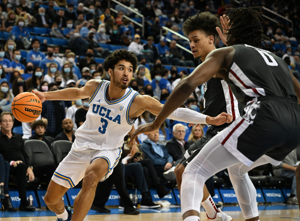 Feb 17, 2022; Los Angeles, California, USA; UCLA Bruins guard Johnny Juzang (3) controls the ball while defended by Washington State Cougars forward DJ Rodman (11) and forward Efe Abogidi (0) in the second half of the game at Pauley Pavilion presented by Wescom. Mandatory Credit: Jayne Kamin-Oncea-USA TODAY Sports