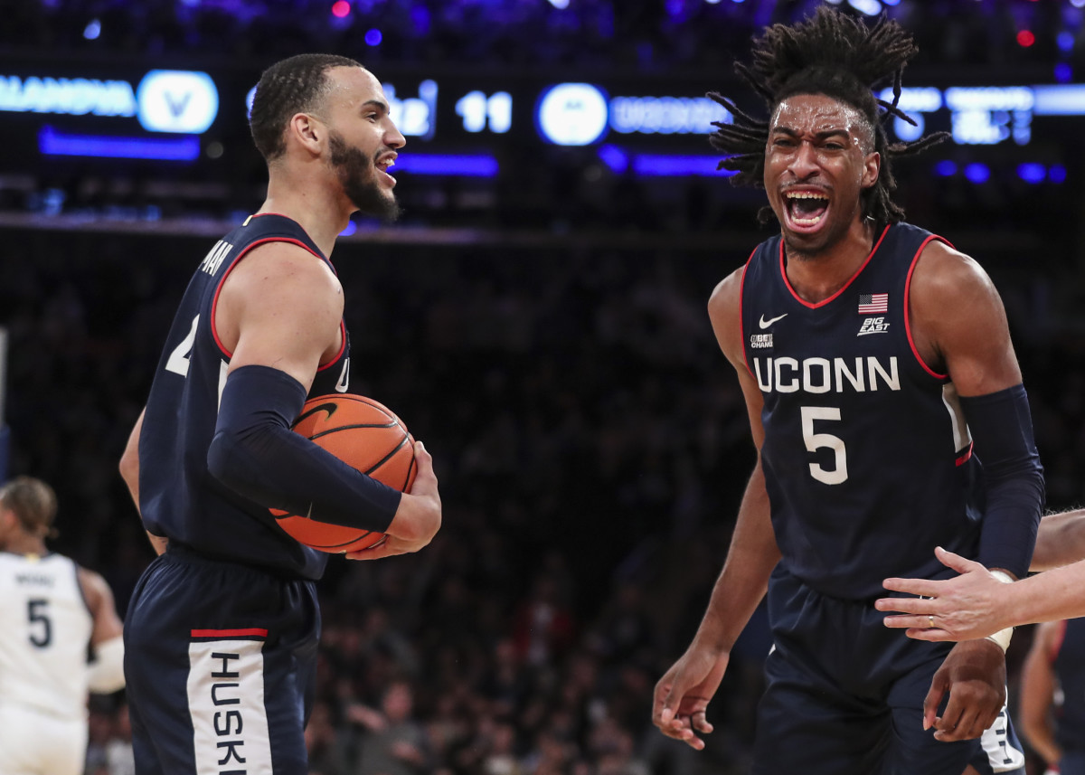 Mar 11, 2022; New York, NY, USA; Connecticut Huskies forward Isaiah Whaley (5) celebrates with guard Tyrese Martin (4) after blocking a shot in the first half against the Villanova Wildcats at the Big East Tournament at Madison Square Garden. Mandatory Credit: Wendell Cruz-USA TODAY Sports