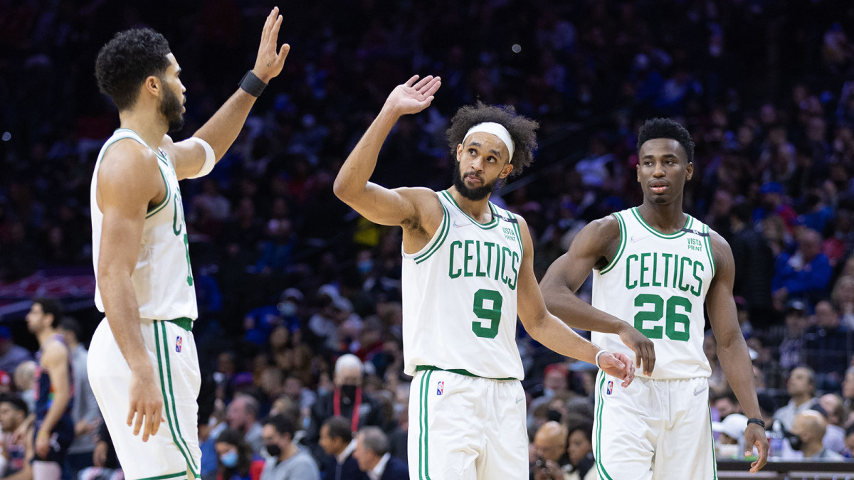 Boston Celtics forward Jayson Tatum (0) and Derrick White (9) and forward Aaron Nesmith (26) react to a score against the Philadelphia 76ers.
