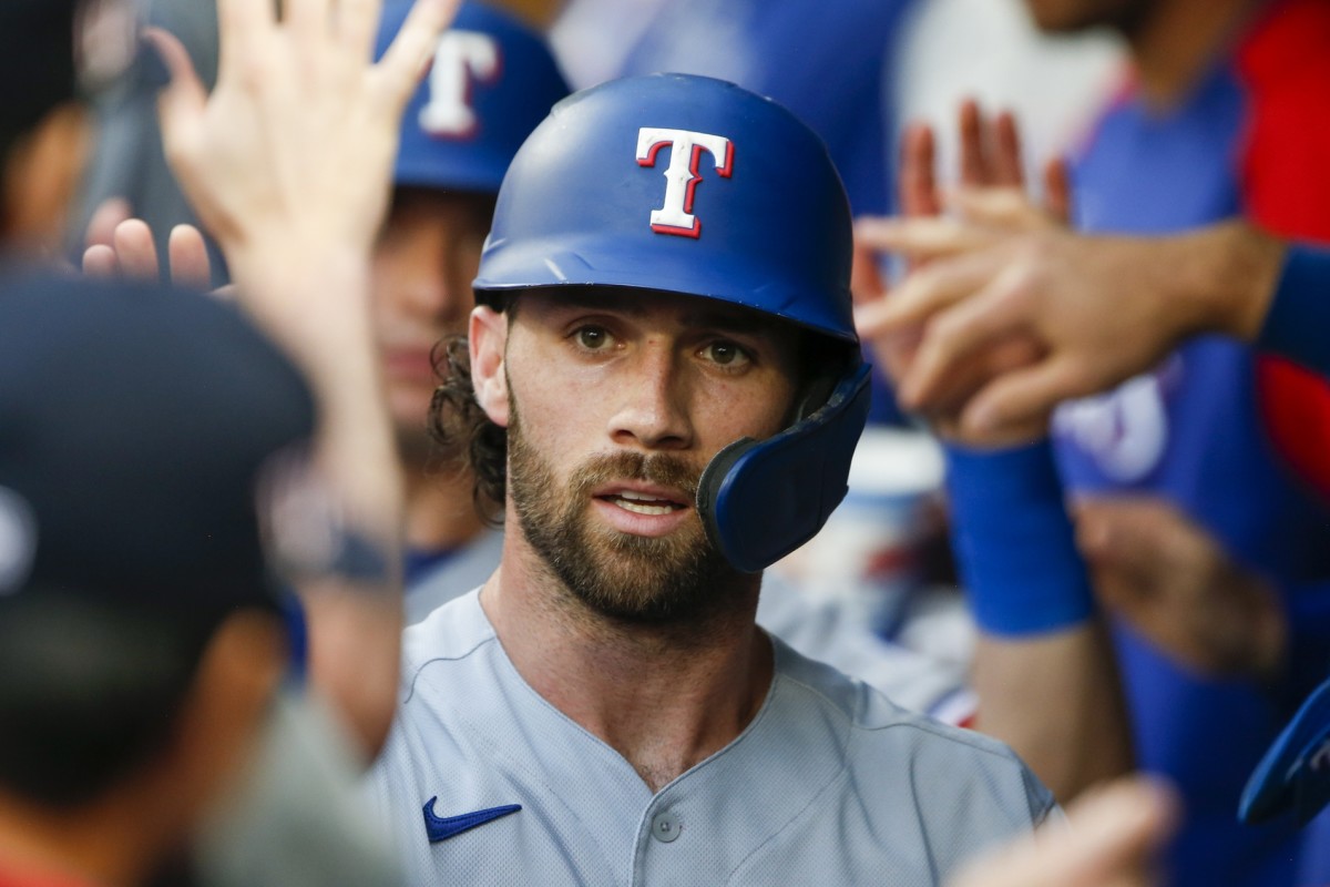 Jul 2, 2021; Seattle, Washington, USA; Texas Rangers shortstop Charlie Culberson (2) is greeted in the dugout after scoring a run against the Seattle Mariners during the third inning at T-Mobile Park. Mandatory Credit: Joe Nicholson-USA TODAY Sports