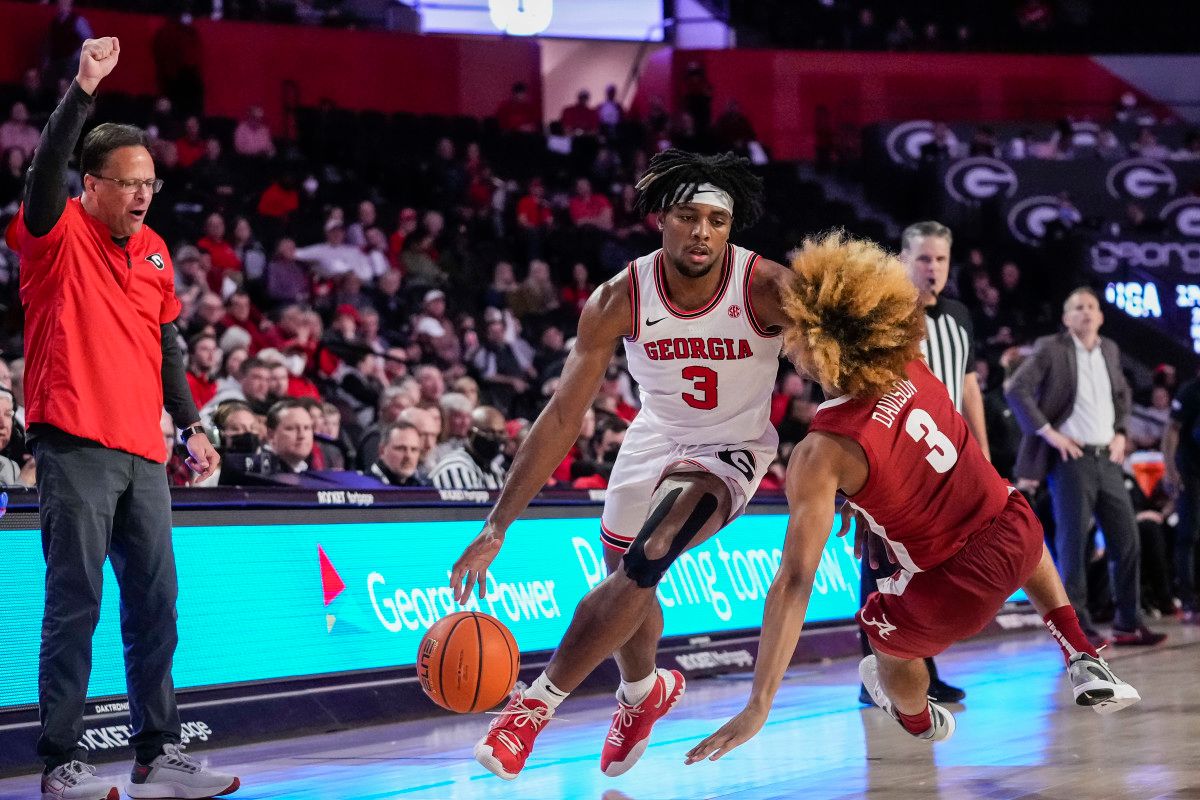 Georgia Bulldogs guard Kario Oquendo (3) dribbles past a falling Alabama Crimson Tide guard JD Davison (3) during the second half at Stegeman Coliseum.