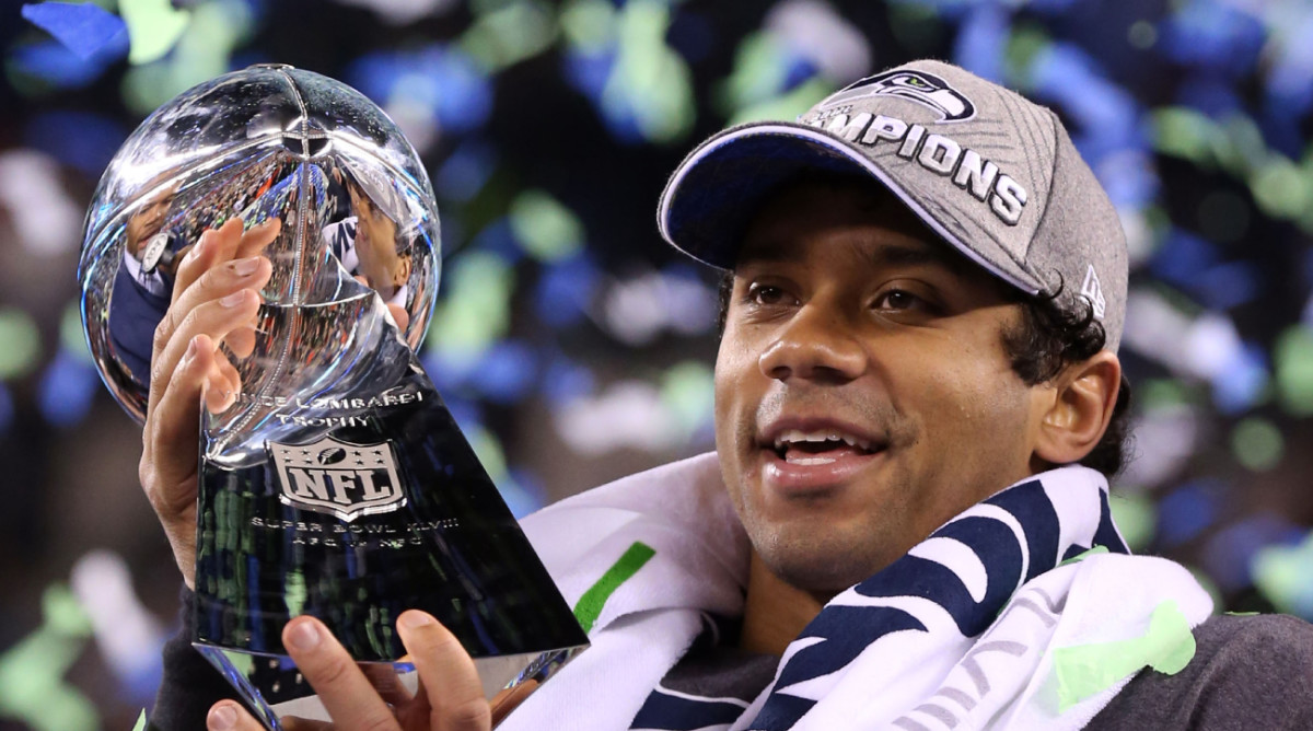 Seattle Seahawks quarterback Russell Wilson (3) celebrates with the Vince Lombardi Trophy after winning Super Bowl XLVIII against the Denver Broncos