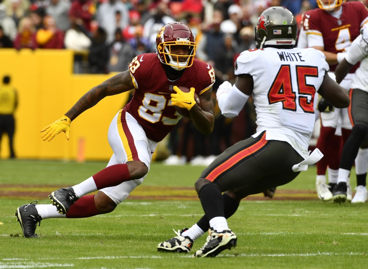 Nov 14, 2021; Landover, Maryland, USA; Washington Football Team tight end Ricky Seals-Jones (83) runs after a catch as Tampa Bay Buccaneers linebacker Devin White (45) defends during the first half at FedExField.